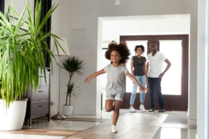 Beautiful young family walking into their new home joyfully