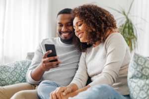 Happy couple viewing there home inspection report on mobile