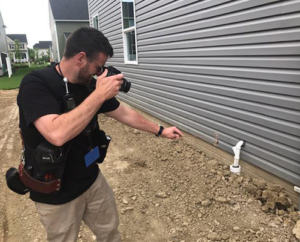 Home Inspector Arthur Duhaime from Clear Home Inspection photographing a electrical ground defect