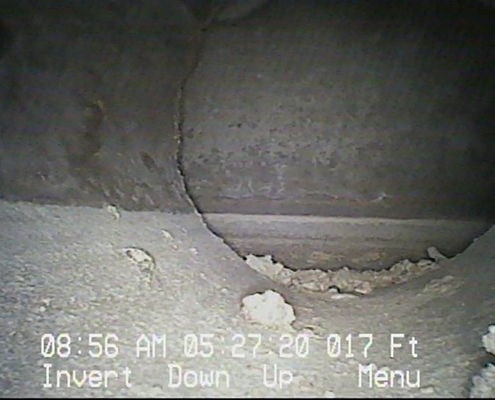 Asbestos containing Transite duct pipe viewed from the inside during a subsurface duct inspection. This duct has water stains from ground water intrusion